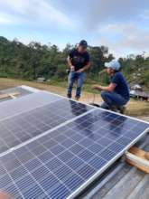 Ricardo and the computer teacher installing panels