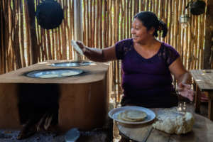 A woman from San Agustin using her new cookstove