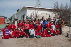School children with rainwater storage tank.