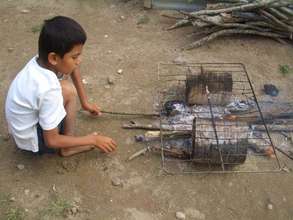 Child cooking over an open-flame