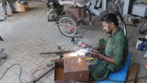 Imran Ghanchi works on the Accessible Tricycle