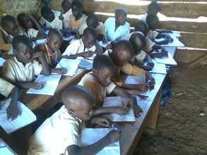 Children using books and pens from Global giving