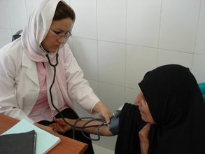 Doctor examining patient in Herat clinic