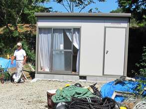 Carpenter Takeshi Shimonishi inspects fishing shed