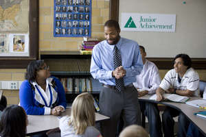 JA volunteer teaching a high school program