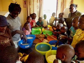 Children follow closely during a baking session