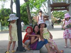 Ms. Thuy, IMCRA staffer, with youngsters in Hanoi