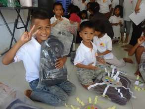 Children enjoy new bags and T-shirt