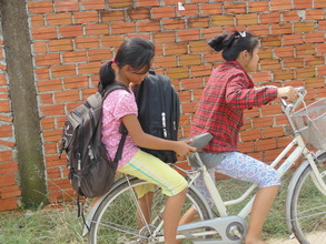 Children riding home with school supplies.