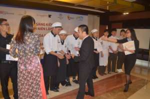 Cuong gets his diploma from the Hilton Hanoi GM