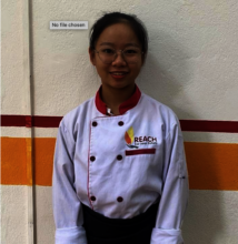 Lanh in her chef uniform at REACH!