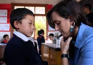 A volunteer screens a child for heart disease