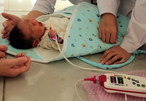 Baby being checked for newborn heart disease.