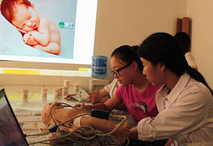 China Cal trainer teaches how to screen newborns.