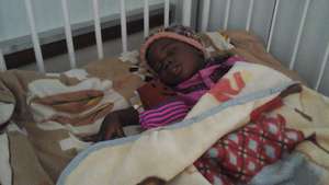 Tanya and her doll cuddling soon after chemo