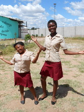 Lindiwe and Charity model the uniforms they made