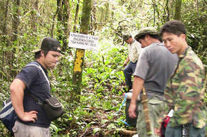 Taking GPS readings at forest border with leaders