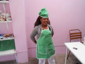 Lindiwe with her apron and hat made for a client