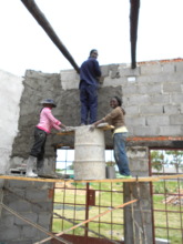 Sithabisiwe plastering cement on new building