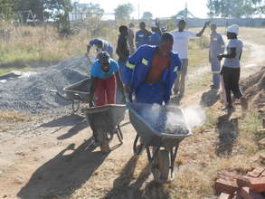 Loreen races with gravel filled wheelbarrows