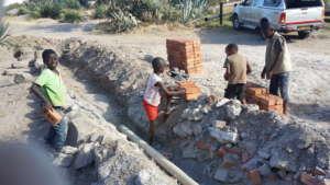The little ones loved learning to lay brick path