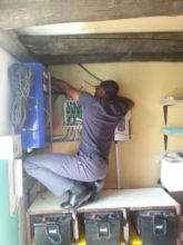 Ngqabutho maintaining our solar electric equipment