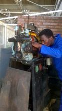 Shaun learning auto mechanics at training course
