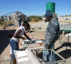 Trainees learning to cut tile
