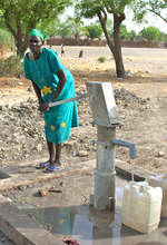 Woman pumping at a new well