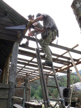 Volunteers Jamie and John working on the roof