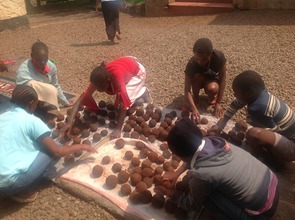 Girls Drying Brickets at the Shelter