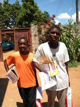 Samuel and Douglas receiving school supplies