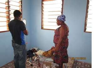The doctor and Sister Kafui, administering to C.A.