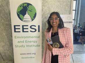 Aastha with her Hill staff badge at EESI's EXPO
