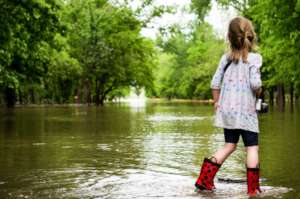 Girl Walking Through Flood