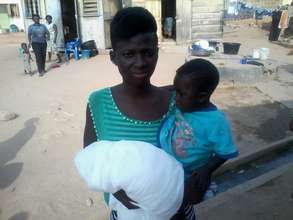 Margaret and child. Note the open drainage behind