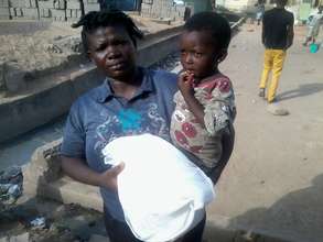 Veronica and child. Note the open drainage behind
