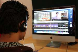 Kelzang edits his micro-documentary on a Lab Mac