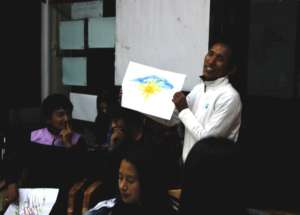 A participant shares his art with the rest