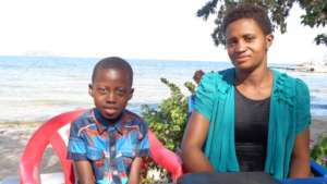 Junior and his mother meeting with GLK Trustees