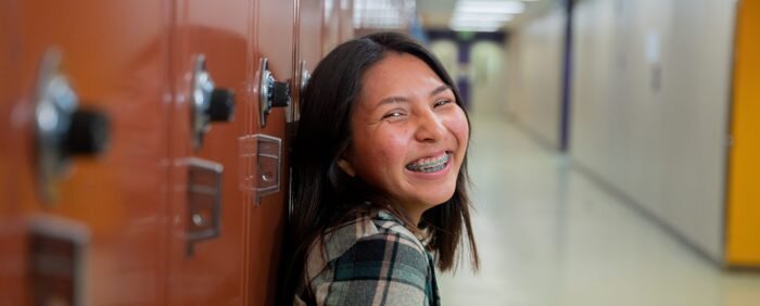 Student leaning against lockers