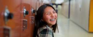 Student leaning against lockers