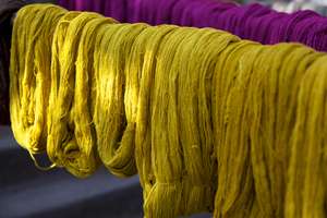 A weaver's colourful work is hanging out to dry