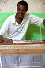 An EDGET weaver proudly displays his workspace