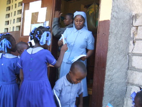School Principal Sr Christiane Distributing Books