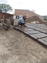 Maria making bricks by hand.