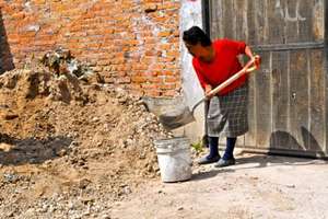 Juana gladly helps build Casita #47, her new home.