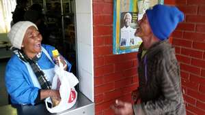 Receiving a food parcel and sharing a laugh!