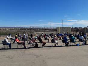 One of several groups waiting in line for food.
