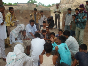 Photo-- Aman Singh, project leader, talks to community about tre